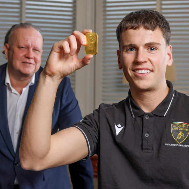 Nigel Doolin, CEO at Core Bullion Traders with Alex Denning announcing their sponsorship of the young Irish driver for the 2026 racing season. Alex is Ireland’s first official junior driver for Lamborghini and will compete in the prestigious Italian GT Championship this year - Here he holds a 10oz solid Gold bullion bar valued (at time of print) at over €43,000.